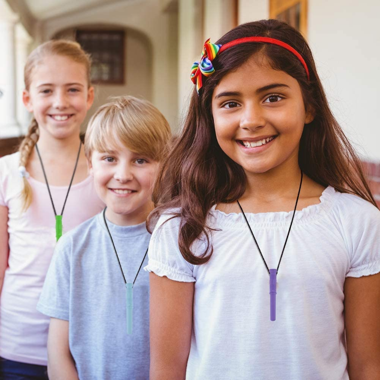 Sensorii's chewies necklace- 2 girls and 1 boy wearing Sensorii's chewie noodle necklace in green, blue and purple