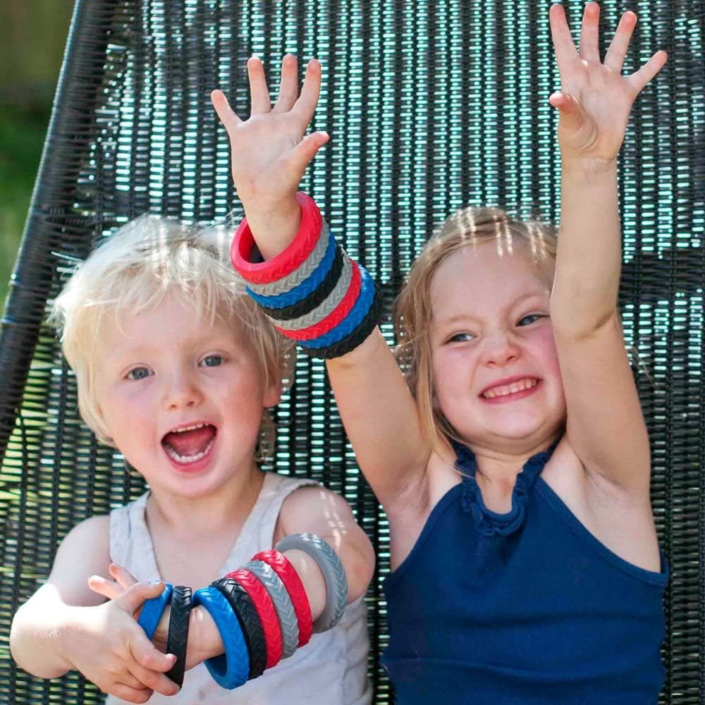 Sensorii's chewies bangle - girl and boy wearing each 8 of Sensorii's chewie bangle in red, blue, grey and black 