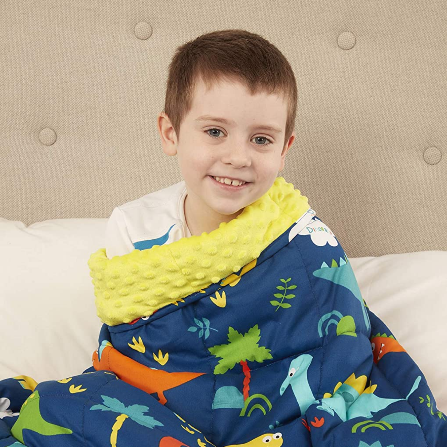 Sensorii's weighted blanket- Boy wrapped up in Sensorii's child weighted blanket in blue and yellow